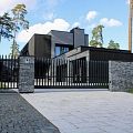 Custom metal fence installation near the house with a modern design
