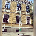 washing windows with a ladder