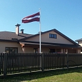 Latvian flag in the yard of a private house
